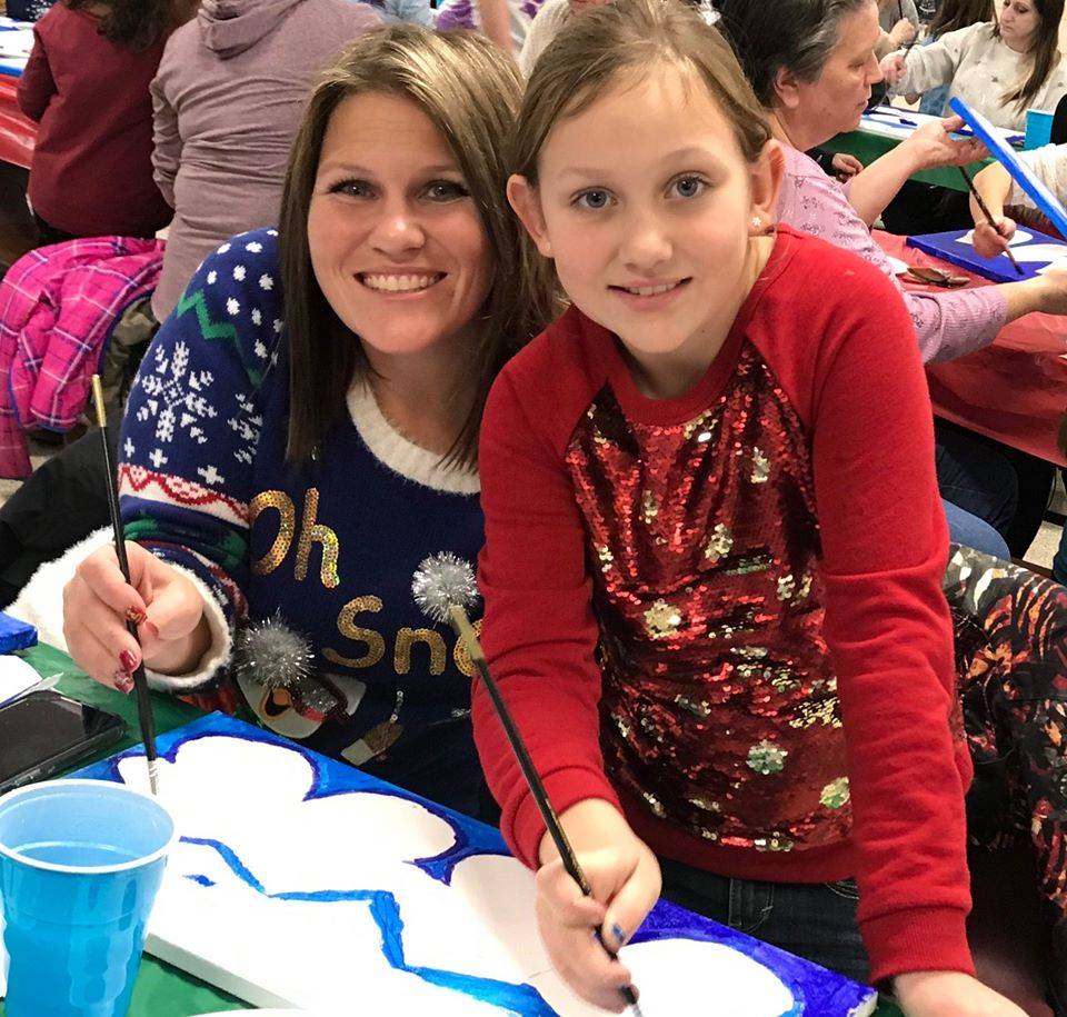 Photo 6:  Mother and daughter smiling for a posed photo while painting during the Park Elementary Ge